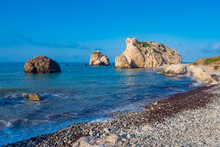 Cyprus. Rock Aphrodite On The Background Of Blue Sky. The Beaches Of The Republic Of Cyprus. The Rock Of Love. Aphrodite Stone On The Shore Of The Mediterranean Sea. Nature Near The City Of Paphos.