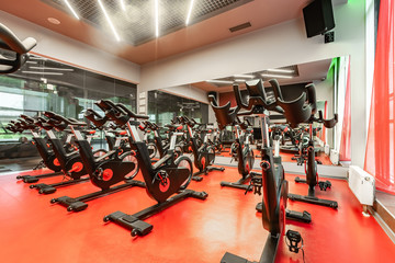 Stationary Spinning bicycles. Indoor cycling for lifestyle design. Fitness background. Healthy lifestyle background. Spinning class with empty bikes. Sport background. Sport, recreation, lifestyle