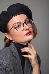 Wall Mural - Beautiful business woman brunette in black beret and eyeglasses.