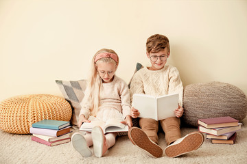 Wall Mural - Little children reading books near color wall