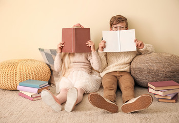 Canvas Print - Little children reading books near color wall