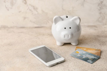 Sticker - Credit cards with piggy bank and mobile phone on grey background. Concept of online banking