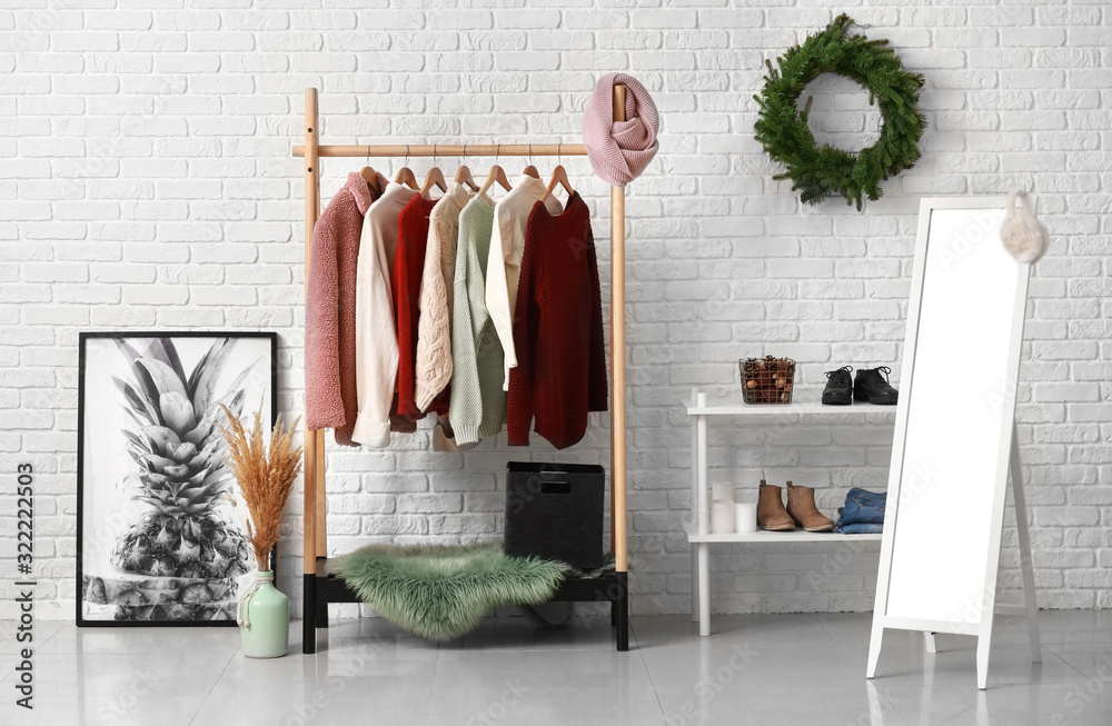 Interior of modern dressing room with winter clothes