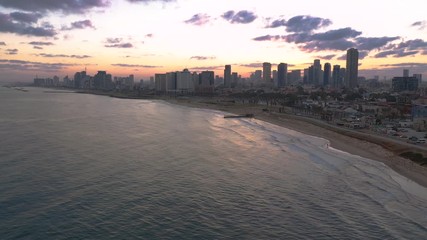 Wall Mural - Flight toward Tel Aviv from Jaffo during a summer sunrise as the modern metropolis awakes in Israel