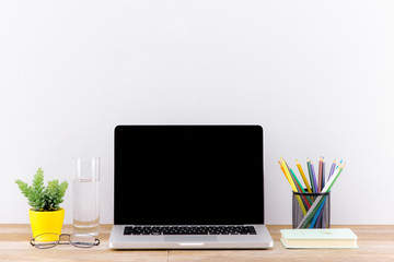 Wall Mural - Mock up laptop, notebook on young student desk. Cyan pastel colors.