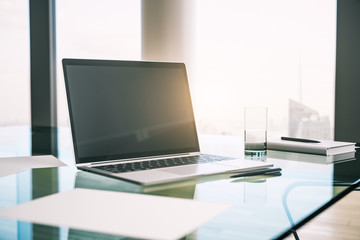 Wall Mural - Morning desktop with laptop and a window with a city view. Mockup. 3D Rendering