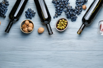 Delicious wine with snacks on wooden background