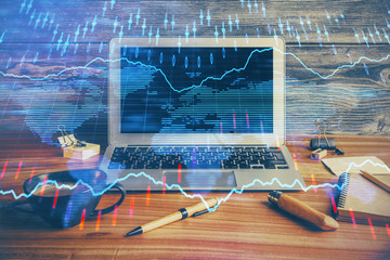 Double exposure of forex graph and work space with computer. Concept of international online trading.