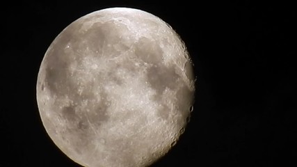 glowing full moon dramatic night moody sky clouds passing detailed moon crater surface. clip fifteen