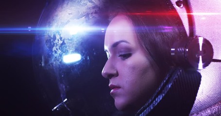 Wall Mural - young beautiful female astronaut in space helmet looking at camera. she is exploring outer space in 