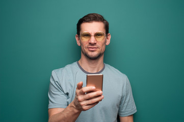 Wall Mural - Portrait of a young man with smartphone