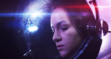 Wall Mural - young brave beautiful female astronaut in space helmet looking at camera. she is exploring outer spa