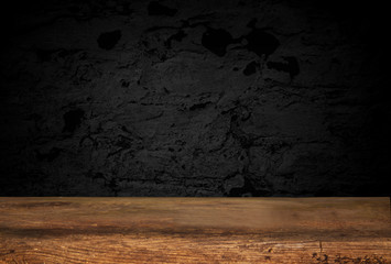 Empty wooden table on a background of dark blurred wall, empty space for product above