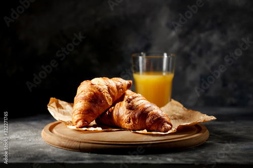 Fotomural Dark mood background and fresh croissants on board