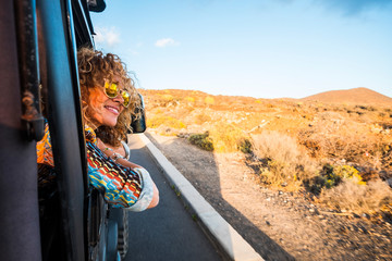 happy beautiful free modern caucasian woman travel on the road with a car - transport and people enj