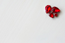 Red Crystals Of Beads On A White Wooden Background