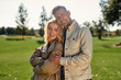 © Svitlana - In love. Portrait of romantic couple hugging and smiling while standing in the middle of the beautiful park