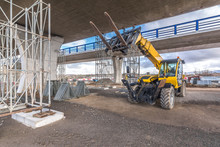 Forklift On A Construction Site, Preparing To Raise Construction Parts