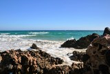 Fototapeta Morze - Beautiful Atlantic ocean shore with rocks and strong waves. Seaside scenery of south-east coast of Fuerteventura, Canary Islands, Spain