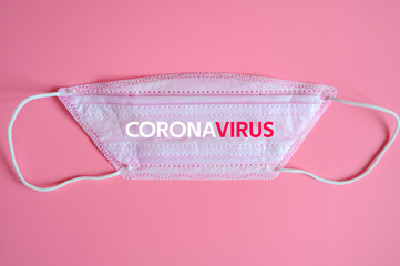 Wall Mural - medical protective disposable pink mask with CORONAVIRUS text. concept protection of outbreak novel dangerous 2019-nCoV influenza coronavirus, mutated and spreading in China and Wuhan. pink background