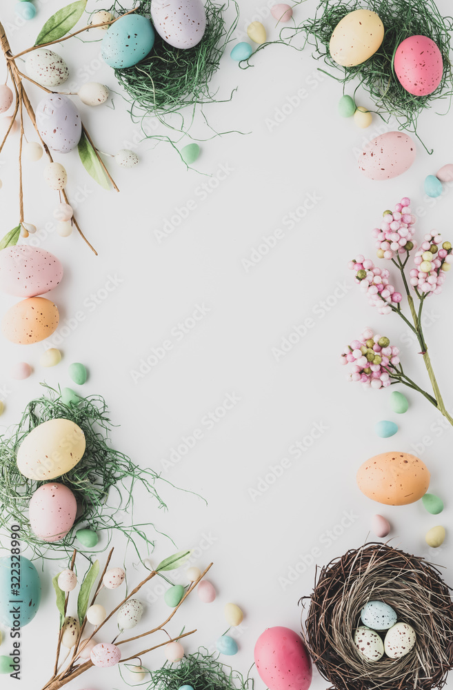 Top down view of an Easter border flat lay including robin's eggs, chocolate eggs and nests in desaturated colours. - obrazy, fototapety, plakaty 