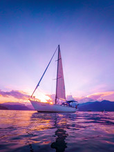 Sailboat In Calm Sea And Incredible Sunset