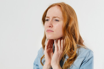 Red hair Woman with sore throat pain portrait close up isolated copy space, sore throat treatment concept, modern medicicne background