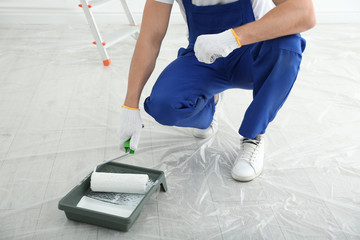 Wall Mural - Man with roller and tray in room, closeup