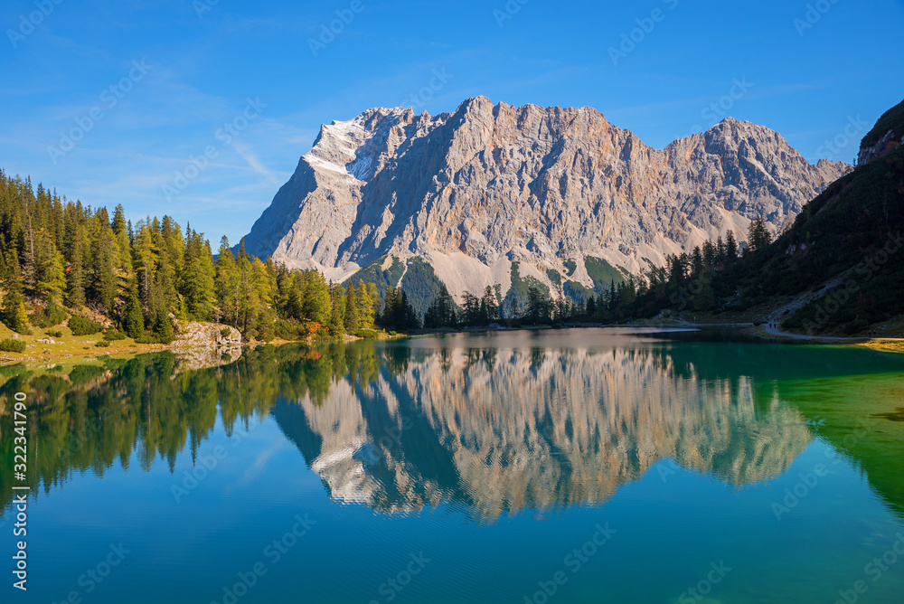 famous Zugspitze mountain mass reflecting in the lake Seebensee. hiking ...