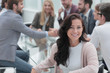 © ASDF - smiling business woman sitting in front of the table in the meeting room