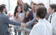 © ASDF - business partners shaking hands as a sign of cooperation