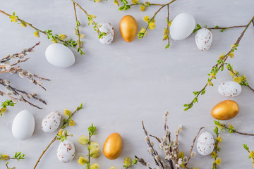 Wall Mural - flat lay easter composition with a willow branch and eggs on a gray background