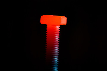 Red-hot metal bolt on a black background