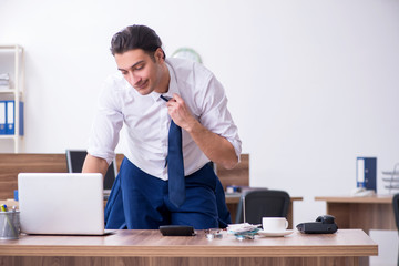 Young male businessman working in the office