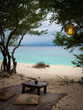 Beautiful beach view on Gili Meno Indonesia between the trees with a mat