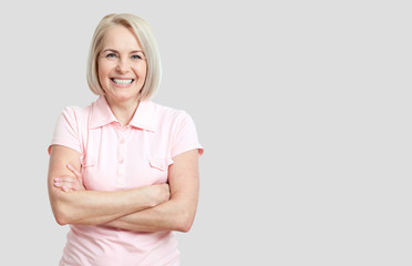 Wall Mural - friendly smiling middle-aged woman isolated on white background