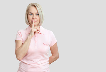Wall Mural - portrait woman with finger on lips, or secret gesture hand sign