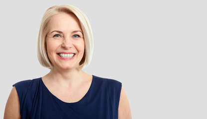Wall Mural - friendly smiling middle-aged business woman isolated on white ba
