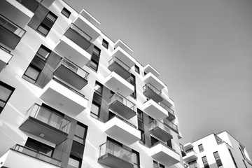 Detail of modern residential flat apartment building exterior. Fragment of new luxury house and home complex. Black and white.