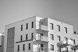 © Grand Warszawski - Detail of modern residential flat apartment building exterior. Fragment of new luxury house and home complex. Black and white.