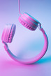 © Screaghin - Retro 90s style photo of white stylish wireless headphone in neon lights. Music concept.