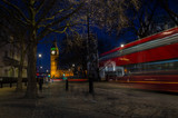 Fototapeta Londyn - London, England, February 16th, 2017: Long exposure with red bus next to Big Ben at Night in London City