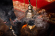 A priest's censer hangs on an old wall in the Orthodox Church. Copper incense with burning coal inside. Service in the concept of the Orthodox Church. Adoration