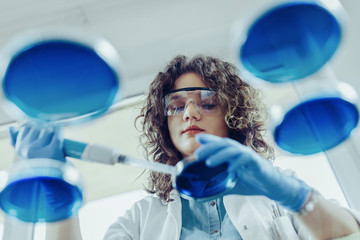 Young scientist working at the lab. Young female scientist doing some research.