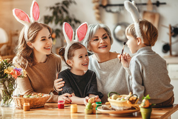 Wall Mural - Happy easter! family mother, grandmother and children paint eggs for holiday.