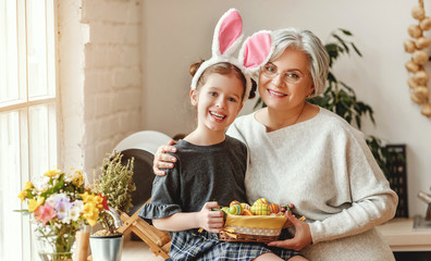 Wall Mural - Happy easter! family grandmother and child with ears hare getting ready for holiday.