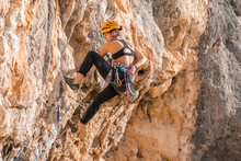 Woman Climbing At Rock Face