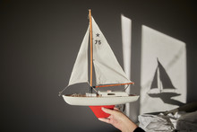 Hand Holding Model Sailboat