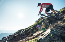 Mountain Biker Mountain Biking Against The Sun In Grisons, Switzerland