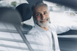 © Westend61 - Portrait of smiling mature businessman in his car